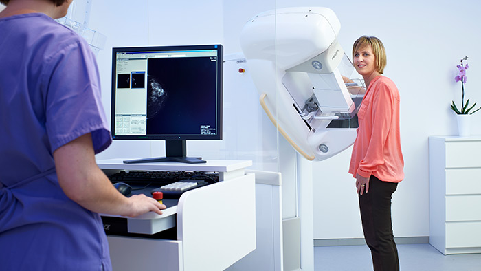 Image of two people near a mammography machine